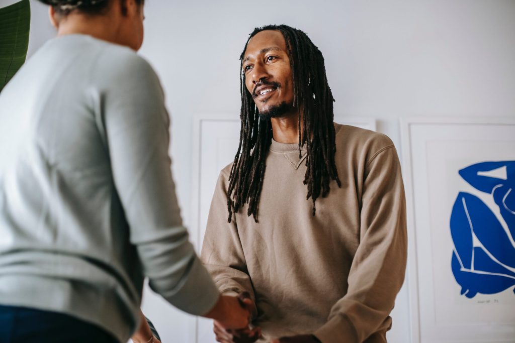 Black man greeting crop psychologist in office